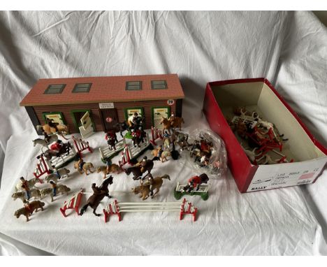 A MODEL STABLE WITH TACK ROOM AND A LARGE QUANTITY OF UNBOXED BRITAINS SHOW JUMPERS, FENCES, PONIES WITH RIDERS ETC 