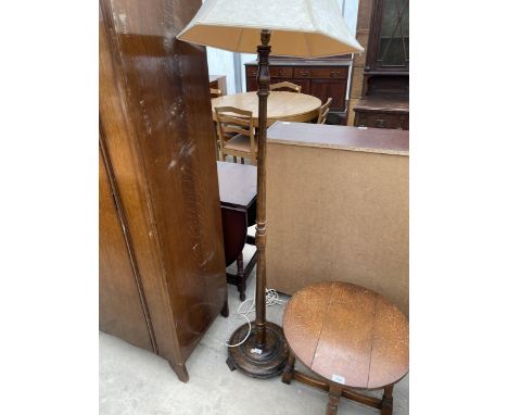AN OAK STANDARD LAMP WITH SHADE 