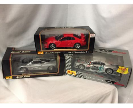 THREE BOXED 1:18 SCALE MODEL CARS - TWO MAISTOS A McLAREN F1, A 2000 SVT MUSTANG COBRA AND A BURAGO MERCEDES SLK-GTR 