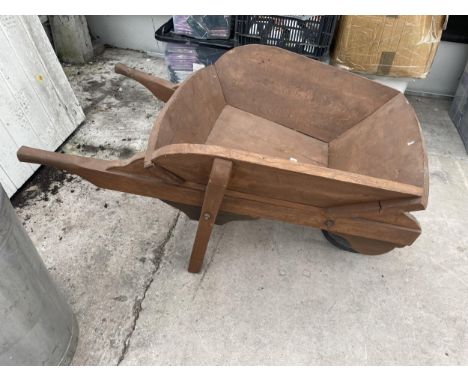 A WOODEN WHEEL BARROW PLANTER CREATED FROM YEW WOOD 