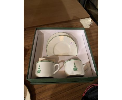 A NEW AND BOXED SET OF TWO CUPS AND SAUCERS WITH TOPIARY DESIGN 
