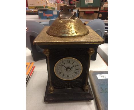 AN UNUSAL MANTLE CLOCK WHICH DOUBLES AS A LIGHTER 