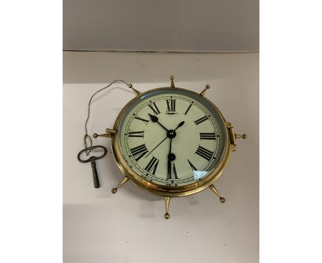 A BRASS MARINE 8 DAY CLOCK IN THE FORM OF A SHIPS WHEEL 