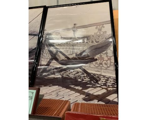 A VERY LARGE KODAK BLACK AND WHITE FRAMED 1940'S/1950'S PRINT OF A LADY SUNNING HERSELF ON THE PIER 156CM X 106CM 