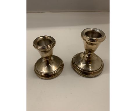 TWO HALLMARKED BIRMINGHAM SILVER WEIGHTED CANDLESTICK HOLDERS APPROXIMATELY 7CM HIGH 