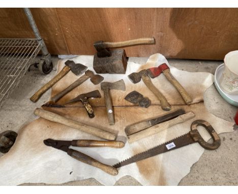 AN ASSORTMENT OF VINTAGE TOOLS TO INCLUDE AXES, A SAW AND LOPPERS ON A DEER SKIN ETC 