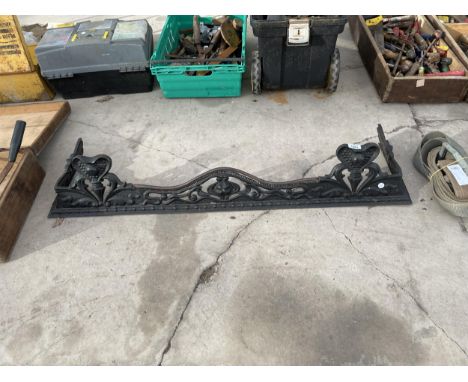 A DECORATIVE CAST IRON FIRE FENDER 