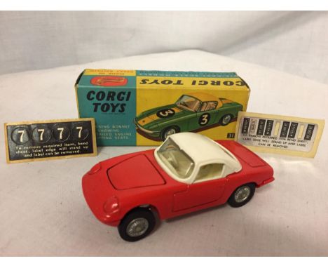 A CORGI LOTUS ELAN COUPE NUMBER 319 WITH STICK ON RACING AND REGISTRATION NUMBERS IN ORIGINAL BOX 