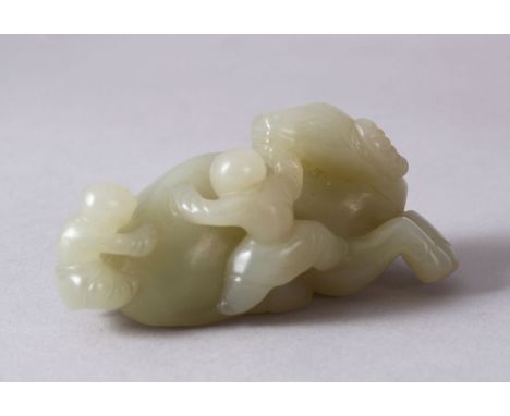 A CHINESE CARVED JADE FIGURE OF AN OXEN AND ATTENDANTs, The oxen in a recumbent position with two young attendant, 9cm wide.