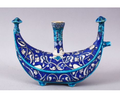 A 19TH / 20TH CENTURY IZNIK POTTERY UNUSUAL HOLY WATER FLASK, with a blue ground and white motif decoration, 22cm wide x 10cm