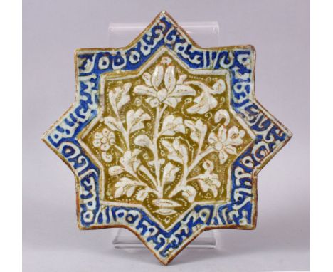 A SELJUK KASHAN STAR SHAPED POTTERY TILE, possibly 13th century, the central panel moulded with floral spray within a stylise