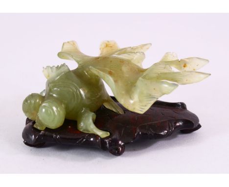A CHINESE CARVED JADE FIGURE OF A GOLDFISH, on a carved wooden base, 10cm.
