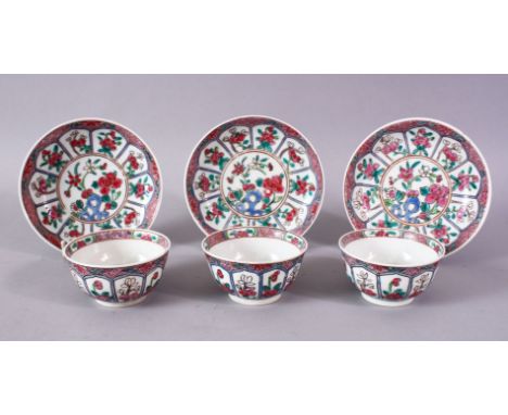 A GOOD SET OF THREE CHINESE FAMILLE ROSE TEA BOWLS AND SAUCERS.