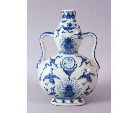 A CHINESE MING STYLE BLUE &amp; WHITE PORCELAIN MOON FLASK, decorated with scenes of phoenix birds amongst stylized clouds, w