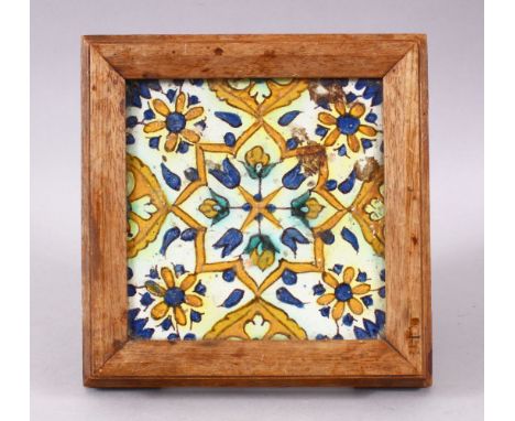 A 19TH / 20TH CENTURY TURKISH POTTERY TILE SECTION, housed within a wooden frame with feet, decorated with floral motifs, 19c