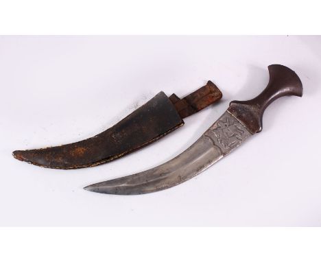 AN 18TH/19TH CENTURY INDIAN JAMBYIA, with steel hilt, the curving blade decorated with hunting scenes, in a leather scabbard,