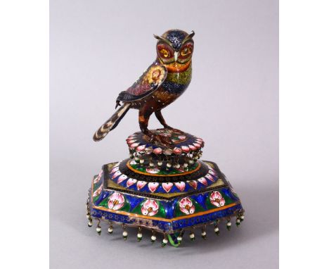 A GOOD 19TH CENTURY INDO - PERSIAN ENAMEL MODEL OF AN OWL, the owl perched, with decoration of floral borders with hanging ta