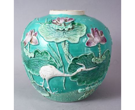 A CHINESE TURQUOISE GROUND PORCELAIN GINGER JAR, with raised relief decoration of a crane amongst lotus sprays, the base with