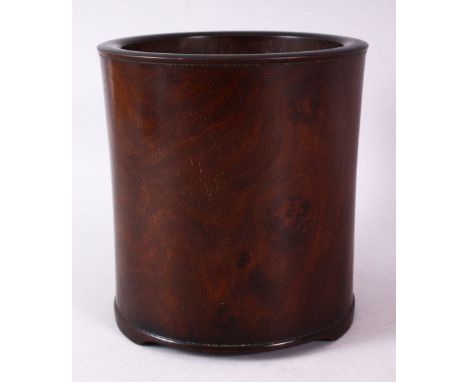 A CHINESE BURR WOOD BRUSH POT, of plain design, on three bracket feet, 16cm high.