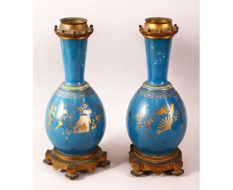 A PAIR OF 19TH CENTURY CHINESE PORCELAIN BOTTLE VASES / LAMP BASES, the ground with gilded decoration and ormolu mounts, 36cm