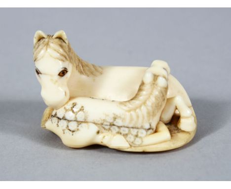 A GOOD JAPANESE MEIJI PERIOD CARVED IVORY NETSUKE OF A RECUMBENT HORSE, to horses in a recumbent position, eyes inlaid with p