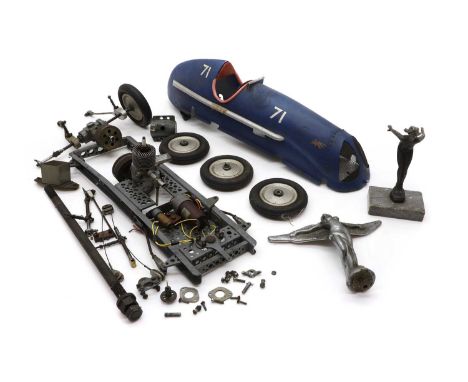 A scratch built model of a racing car, 20th century, with a small engine, dismantled, the body in blue, with a front grille, 