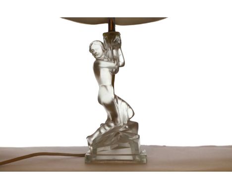 A pair of Art Deco satin glass table lamps modelled as nude figures holding sconces, with cream shades, 22.5cm high to the fi