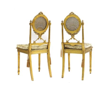 A pair of Louis XVI-style giltwood side chairs late 19th/ early 20th century, French, with arrow shaped backs with a circular