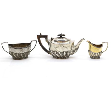 A silver three piece tea service by Charles Stuart Harris, London 1901, comprising teapot, 11cm high, twin-handled sugar bowl