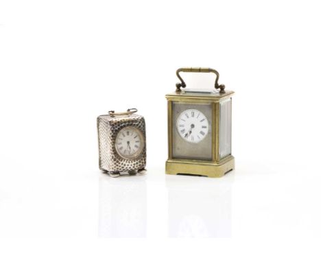 A brass carriage clock the enamelled dial with Roman numerals, to a silvered face, 12cm hightogether a silver minature exampl