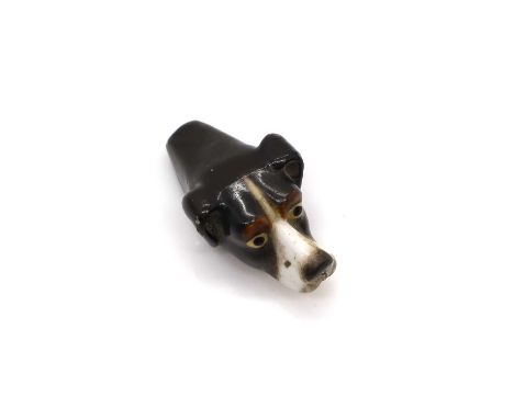 A Royal Worcester porcelain dog whistle, c.1920s, modelled as the head of a dog with painted features, with pierced muzzle, p