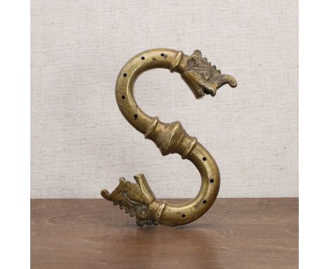 A Mughal brass door knocker, 17th century, Safavid or Deccan India, the pierced tubular body with each terminal cast in the f