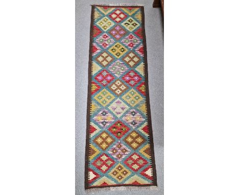 Blue ground Maimana kilim runner&nbsp;with one central row of nine lozenge floral medallions flanked by two similar rows of&n