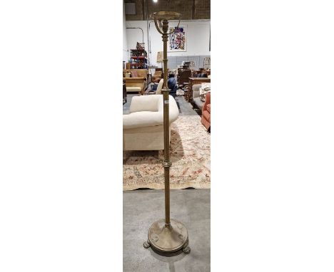 Early 20th century brass standard lamp&nbsp;of telescopic form, raised on a circular pedestal&nbsp; base with three lion's pa
