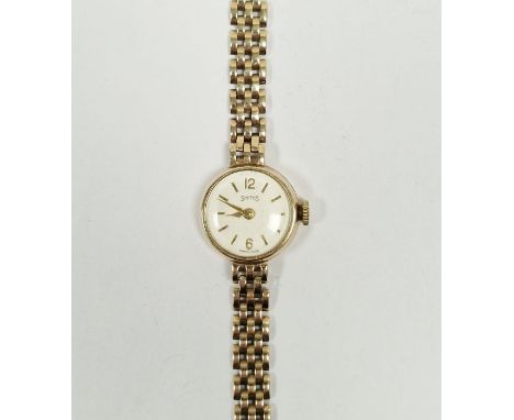 9ct gold Smiths lady's manual wind wristwatch, the circular silvered dial with gilt baton hour markers, 9ct gold case and bra