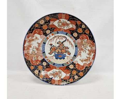 Large Japanese Meiji period (1868-1912) imari charger, painted and gilt with a jardiniere of flowers and terracing, within a 