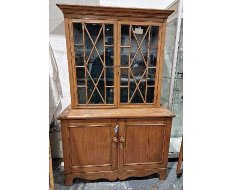 Pine display cabinet, the glazed top with shaped shelves, cupboard below, on bracket feet, 120cm wide&nbsp;