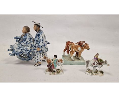 Pair of German small porcelain figures&nbsp;with cattle, modelled carrying baskets of grapes and flowers, a Continental porce