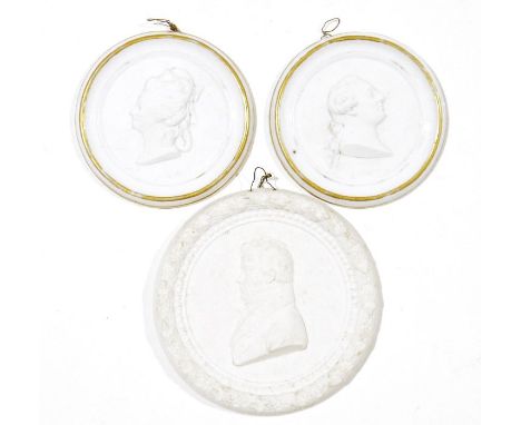 Three French biscuit porcelain portrait medallions, comprising: two Sevres (hardpaste) white and gilt circular plaques of Lou