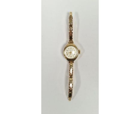 Vintage lady's Smiths 9ct gold wristwatch, the circular dial with alternating Arabic and arrow hour markers, 9ct gold case an