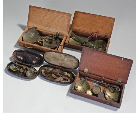 Five sets of apothecary scales, three in wooden boxes, two in metal lacquered boxes, (5)
