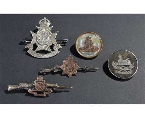 Military sweet heart brooches, the first with rifles an military crests, together with two shell examples, and a cap badge fo