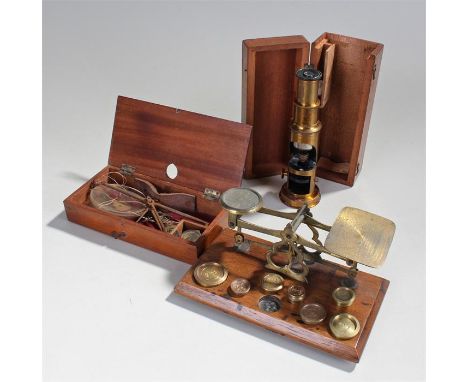 Mixed instruments, to include a microscope, a set of postal scales and a set f apothecary scales, (3)
