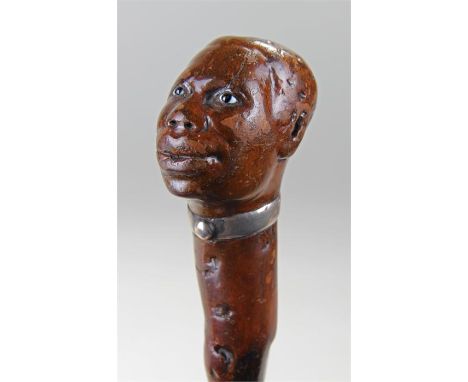 Circa 1876 figural walking stick, with the carved figural head, silvered collar with the rubbed names detailing a gift in 187