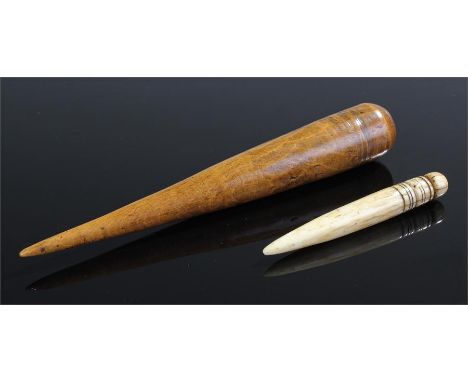 Two 19th Century fids, the first in whale bone with ring turned top, 8cm long, together with a turned ash fid, 15cm long, (2)