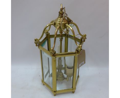 A 20th Century heavy brass hexagonal lantern with bevelled glass panels. H-50cm, W-29cm, D-29cm 