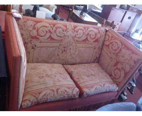 A Knowle end sofa with floral tapestry upholstery on castors, H:114cm W:174cm D:93cm