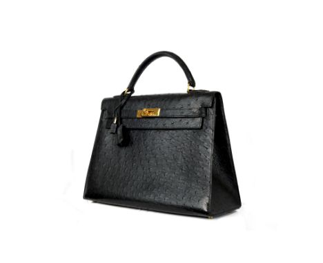 Kelly 32 Sellier handbag made of black ostrich leather with gold hardware, original keys, clochette and lock. Very good vinta