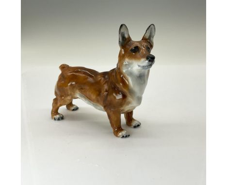 This figurine is inspired by a champion Pembroke Welsh Corgi dog named Spring Robin. She is designed with a golden-brown coat