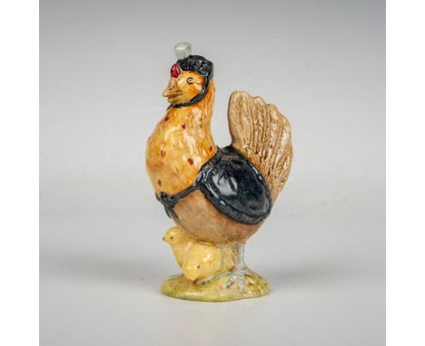 Modeled with brown and gold feathers and wears a black hat and cloak. This item has its original box measuring 2"L x 2.5"W x 